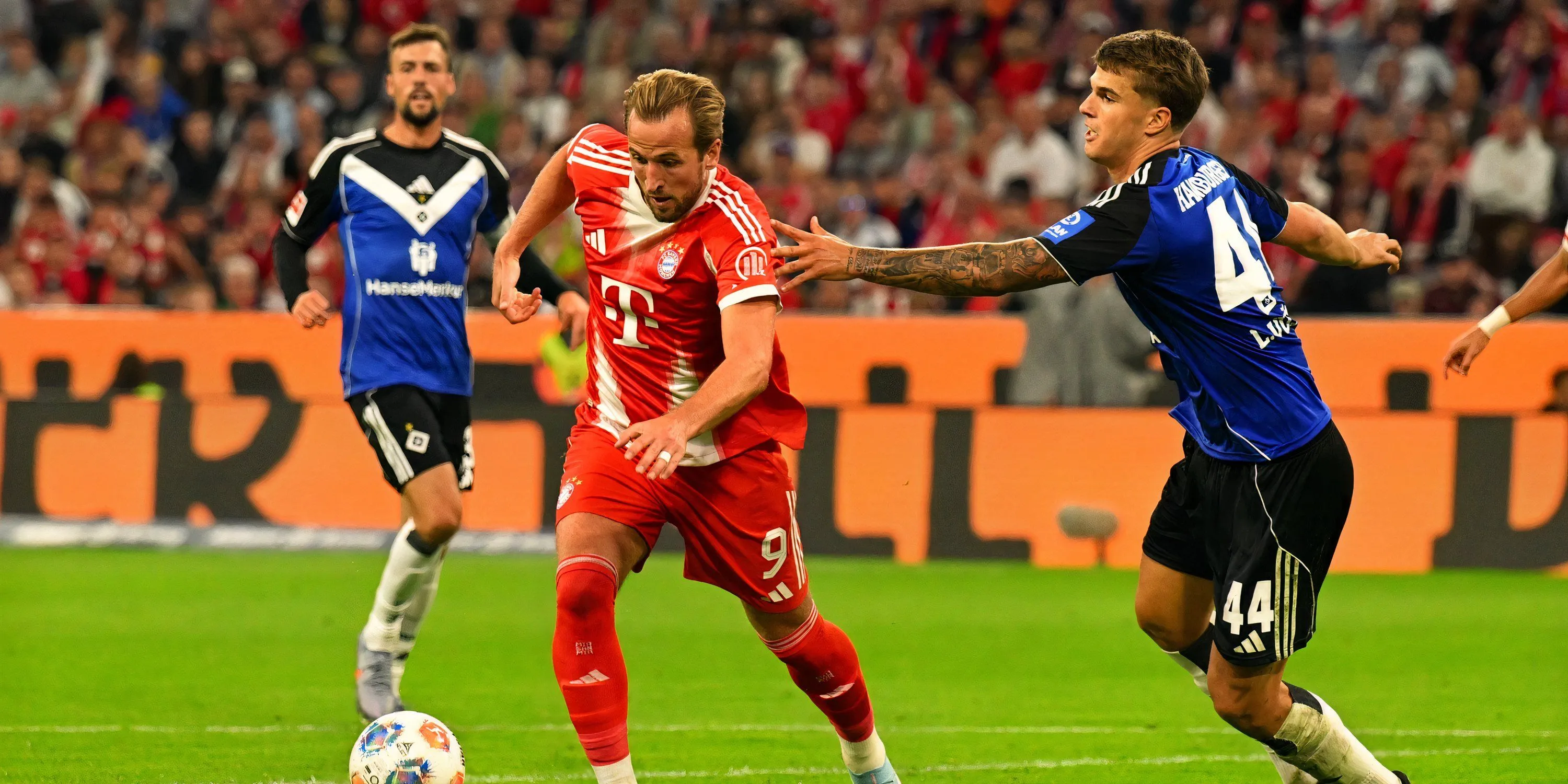 Harry Kane (áo đỏ) tranh chấp với Luka Vuskovic (áo xanh) trong trận đấu giữa Tottenham và Hamburg